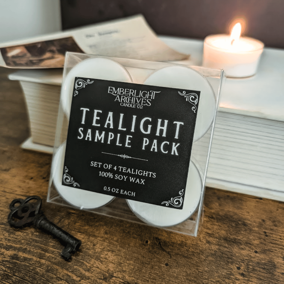 Tealight sample pack with Emberlight Archives label on a wooden surface with a candle in the background.